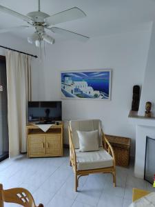 a living room with a chair and a tv at Stylineo Platres in Platres
