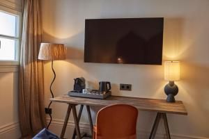 TV a/nebo společenská místnost v ubytování Puro Grand Hotel