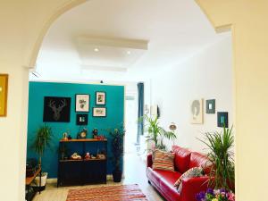 sala de estar con sofá rojo y pared azul en Trastevere Vintage Rosazza en Roma