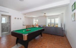 a living room with a pool table and a couch at Holiday Home Aqua in Šmrika