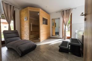 a living room with a chair and a cabinet at Senjska Villa in Josipdol