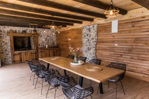 a wooden dining room with a table and chairs at Senjska Villa in Josipdol