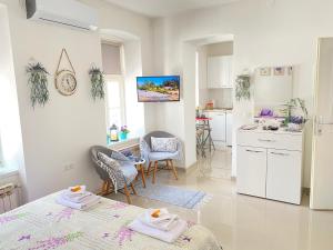 a kitchen and living room with a table and chairs at Korzo Tuzla in Tuzla