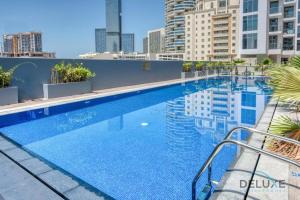 a swimming pool on the roof of a building at Lovely Studio in Pantheon Elysee JVC by Deluxe Holiday Homes in Dubai
