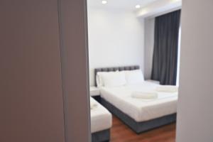 a reflection of a bedroom with a bed and a mirror at SEA & LAKE VIEW VILLA in (( Kalive Gjoka ))