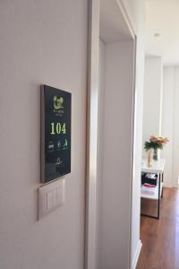 a clock on a wall next to a mirror at SEA & LAKE VIEW VILLA in (( Kalive Gjoka ))