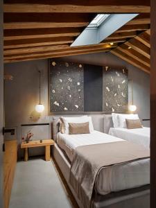 a bedroom with two beds and a skylight at Fornace Suite in Florence