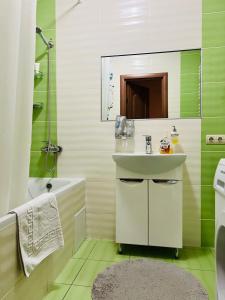 a bathroom with a sink and a mirror at Apartaments Sichovyh Strilciv 68a in Ivano-Frankivsʼk