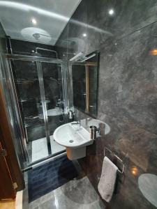 a bathroom with a sink and a shower at Seven in Sliema +5 photos