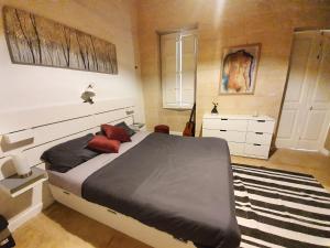 a bedroom with a king sized bed and a rug at Seven in Sliema