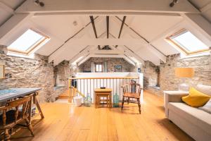 a living room with a couch and a table at Stunning Converted Granary in Heart of St Davids in St. Davids