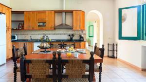 cocina con mesa de madera en una habitación en Casa Can Roure, en Vilassar de Dalt