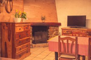 a living room with a table and a fireplace at Complex Rural Can Caubet in Berga