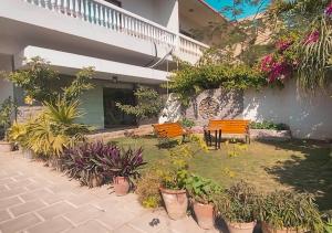 a courtyard with benches and plants in front of a building at Hype Holiday Homes in Karachi