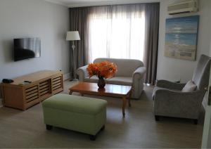 a living room with a couch and chairs and a table at The Riverside Hotel in Durban