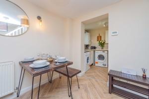 a living room with a table and a laundry room at Coton Hill Shrewsbury Cottage in Shrewsbury