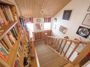an overhead view of a staircase in a house with books at Moonlight House Large holiday villa with sauna and free parking in Rovaniemi