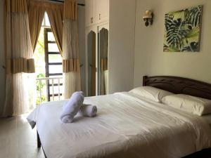 a stuffed animal is sitting on a bed at The Nook, Kuala Terengganu in Kuala Terengganu +10 photos