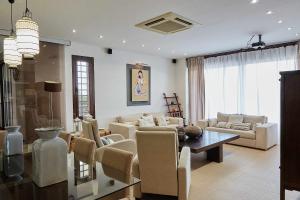 a living room with couches and a table and chairs at Villa Alcotán Layos by Toledo AP in Layos