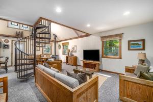 a living room with a spiral staircase in a house at Shady Pines in Thompsonville