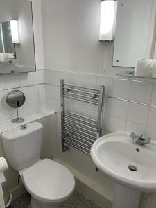a white bathroom with a toilet and a sink at Alder en-suite self caring private shower 2 in Southampton