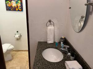 a bathroom with a sink and a toilet at KASA Roof Top 6 1 bed 1 bath for 2 Guests AMAZING Views Old San Juan in San Juan