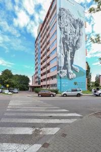 a building with a large mural on the side of it at Seaview Apartment Gdańsk Przymorze by Renters in Gdańsk