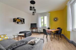 uma sala de estar com um sofá e uma mesa em "Urbaine Cosy" Elégance, confort et détente en Alsace "Les Péri-Urbaines" em Riedisheim