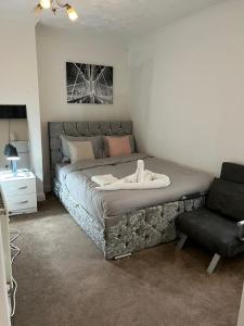 um quarto com uma cama grande e uma cadeira em Alder en-suite self caring private shower 2 em Southampton