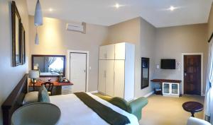 a large bedroom with a bed and a desk at Komani Resorts in Queenstown