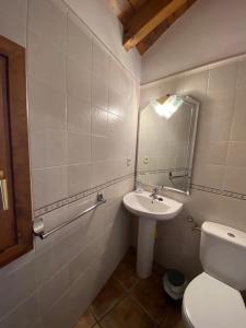 a bathroom with a sink and a toilet and a mirror at CASA SUERTES-FISCAL in Fiscal