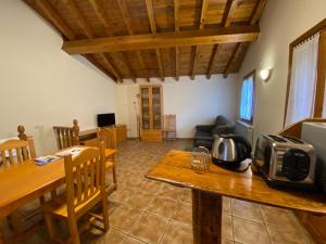 a living room with a table and a dining room at CASA SUERTES-FISCAL in Fiscal