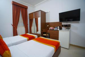 Ένα ή περισσότερα κρεβάτια σε δωμάτιο στο La Villa Hotel