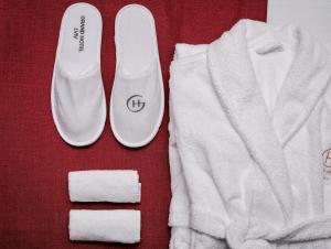 a pair of white shoes and towels on a table at Grand Hotel Lviv Casino & Spa in Lviv