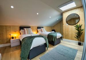 a bedroom with two beds and a mirror at Green Mews 1 with Free Parking - By My Getaways in Brighton & Hove