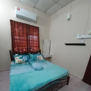 a bedroom with a bed with a red curtain at HAIDA'S HOMESTAY Seri Iskandar, Perak in Seri Iskandar