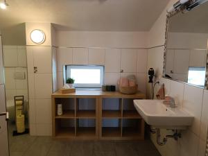 a small bathroom with a sink and a mirror at Ferienwohnung Sonja in Bach