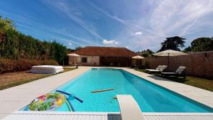 a swimming pool in the backyard of a house at La Templerie - Chambres d'hôtes in La Flèche