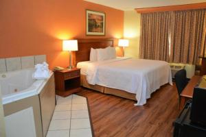 a hotel room with a bed and a bath tub at Buckeye Inn near OSU Medical Center, Columbus OH I-71 By OYO in Columbus