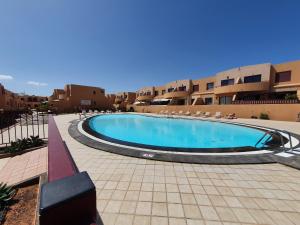 a swimming pool in the middle of a courtyard at Allamanda Home in Caleta De Fuste