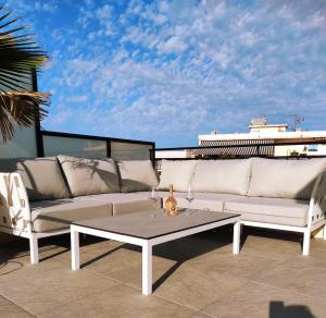 a couch and a coffee table on a balcony at Rooftop condo RAMSES in Antibes