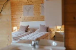 a bedroom with two beds and two lamps at Ferienwohnung Karawankenblick in Rosegg