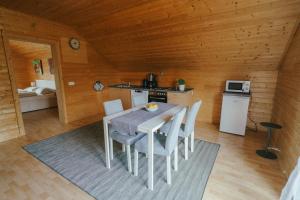 a kitchen with a table and chairs in a cabin at Ferienwohnung Karawankenblick in Rosegg