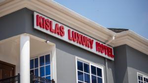 a sign on the side of a building at Kislas Luxury Hotel in Pantang