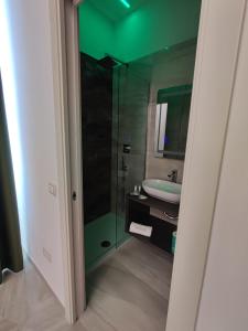 a bathroom with a glass shower and a sink at Twin Towers Naples Luxury in Naples