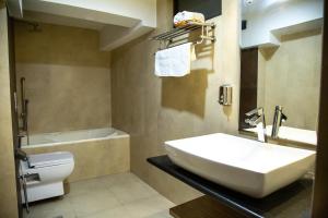 a bathroom with a sink and a tub and a toilet at Hotel Traditional in Bhaktapur