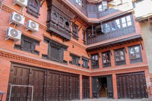 a tall brick building with balconies on it at Hotel Traditional in Bhaktapur