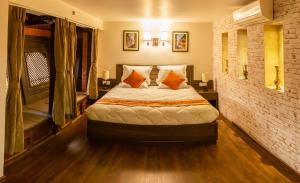 a bedroom with a bed and a brick wall at Hotel Traditional in Bhaktapur