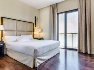 a bedroom with a large bed and a large window at Hotel 525 in Los Alcázares