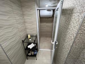 a bathroom with a shower with a glass door at Апартамент Панорама Рози in Sandanski +35 photos
